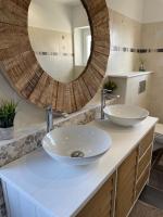 a bathroom with two sinks and a large mirror at Aurefees in Ellon