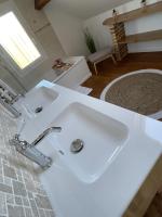 a bathroom with a white sink in a room at Aurefees in Ellon