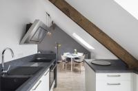 a kitchen with a sink and a dining room at LE NOROIT - Cocon lumineux sur le Sillon in Saint Malo