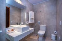 a bathroom with a sink and a toilet at Barra do Piuva Porto Hotel in Ilhabela
