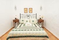 A bed or beds in a room at Casa Rural La Capellania