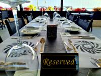 a long table with a reserved sign at a restaurant at The Ciao Stelio Deluxe Boutique Hotel - Adults Only in Larnaka