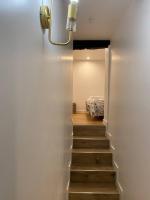 a hallway with a staircase leading to a bedroom at Appartement Rouen Le Voltaire Home in Rouen