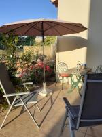 a patio with an umbrella and a table and chairs at Bompastor in Bompas