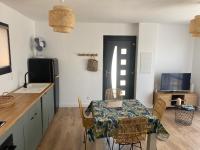 a kitchen with a table and some chairs and a television at Maison avec vue sur le massif de l Étoile in Marseille