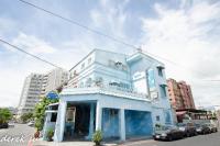 a blue building with a balcony on a street at Lantian Baiyun in Hualien City