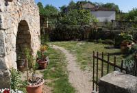 a garden with potted plants and a stone wall at Apartments with a parking space Zupanje, Krk - 5307 in Županje
