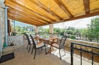 a wooden table and chairs on a patio at Apartments with a parking space Zupanje, Krk - 5307 in Županje