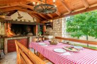 a dining room with a table with a red and white checkered table cloth at Studio Nin 5666b in Nin