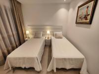A bed or beds in a room at Garden Suites luxury apartment