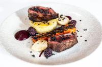 a white plate with a dessert with fruit and berries at Dalmunzie Castle Hotel in Glenshee