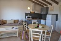 a kitchen and living room with a table and a couch at Résidence Marina Di Santa Giulia in Porto-Vecchio