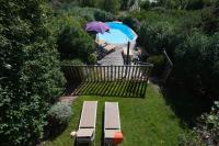 an overhead view of a pool with a bench and an umbrella at Résidence Marina Di Santa Giulia in Porto-Vecchio