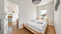 Posteľ alebo postele v izbe v ubytovaní Apartamenty Sun & Snow Baltic Sun z basenem i placem zabaw