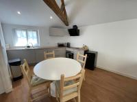 a kitchen and dining room with a table and chairs at Appartement Le Voltaire centre ville climatisé in Saumur