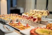 a buffet of appetizers and desserts on plates on a table at Bizerta Resort Congres & SPA in Bizerte