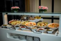a buffet with many bowls of food on a table at Bizerta Resort Congres & SPA in Bizerte