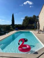 a swimming pool with a swan in the water at Gite Le Meix Chapeau in Levernois
