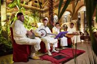 a group of men sitting in a room with instruments at Heure Bleue Palais - Relais & Châteaux in Essaouira