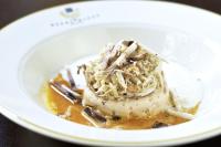 a white plate with a piece of ice cream with nuts at Heure Bleue Palais - Relais & Châteaux in Essaouira