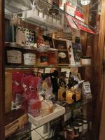 a shelf filled with books and other items in a store at Hôtel Du Théâtre Centre Historique Parking Gratuit in Metz