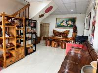 a room with a room with wooden shelves and a table at Golden flower Homestay in Yuli