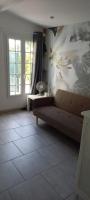a living room with a couch and a flower wall at Studio in Sorgues
