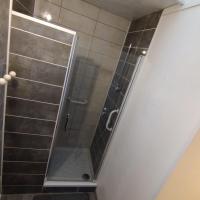 a shower with a glass door in a bathroom at Halles Brauhauban Tarbes - T6 en collocation - Louez votre chambre in Tarbes