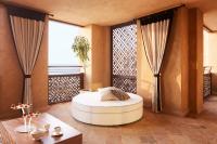 a room with a round bed in a room with windows at Jumeirah Mina Al Salam Dubai in Dubai