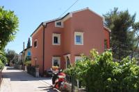 a house with a scooter parked in front of it at Apartments by the sea Cres - 8095 in Cres