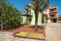 a house with a palm tree and a bunch of bananas at Apartments with a parking space Bozava, Dugi otok - 8124 in Božava