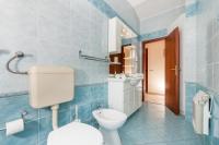 a blue tiled bathroom with a toilet and a sink at Apartments with a parking space Bozava, Dugi otok - 8124 in Božava