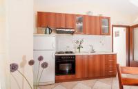 a kitchen with a white refrigerator and a sink at Apartments with a parking space Bozava, Dugi otok - 8124 in Božava