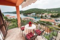 a balcony with a table and chairs and a view of the water at Apartments with a parking space Bozava, Dugi otok - 8124 in Božava