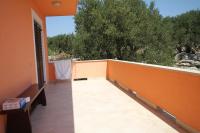 a balcony of a house with an orange wall at Apartments with a parking space Bozava, Dugi otok - 8124 in Božava