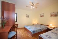 a bedroom with two beds and a ceiling fan at Apartments with a parking space Bozava, Dugi otok - 8124 in Božava