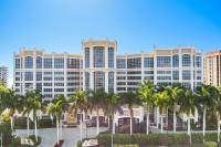 ein großes Gebäude mit Palmen davor in der Unterkunft Marco Beach Ocean Suites in Marco Island