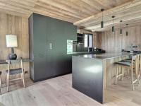a kitchen with a black counter and wooden walls at Chalet Morzine, 5 pièces, 8 personnes - FR-1-627-66 in Morzine