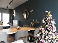 a christmas tree in a dining room with a table at Splendid Holiday Home in Le Tignet South with Garden in Eisden