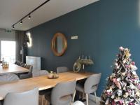 a christmas tree in a dining room with a table and chairs at Splendid Holiday Home in Le Tignet South with Garden in Eisden