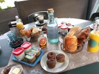 a table with a bunch of breakfast foods and drinks at Chambres d&#39;hôtes &amp; jacuzzi - A l&#39;ombre des amandiers in Saint-Martin-dʼArdèche