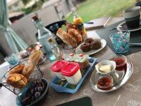 a table topped with plates of food and pastries at Chambres d&#39;hôtes &amp; jacuzzi - A l&#39;ombre des amandiers in Saint-Martin-dʼArdèche