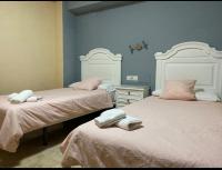 A bed or beds in a room at Hotel Medina Centro