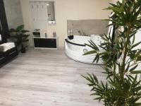 a bathroom with a white tub in the middle at Hôtel Saint Albert in Sarlat-la-Canéda