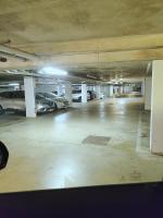 un estacionamiento vacío con coches aparcados en él en III Appart 2 Pièces, Neuf 200 m de Gare Parking Netflix Evry Courcouronnes, en Courcouronnes