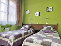 A bed or beds in a room at Hostal San Martin