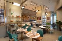 a restaurant with tables and chairs and a counter at Summit Galleria Cebu in Cebu City