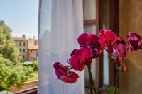 a vase of purple flowers sitting on a window sill at Hotel Orsaria in Venice
