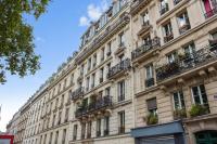 a large building with balconies on a street at Nice studio w balcony on Square Gardette in Paris - Welkeys in Paris