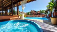 a swimming pool in the middle of a house at Búzios Centro Hotel in Búzios